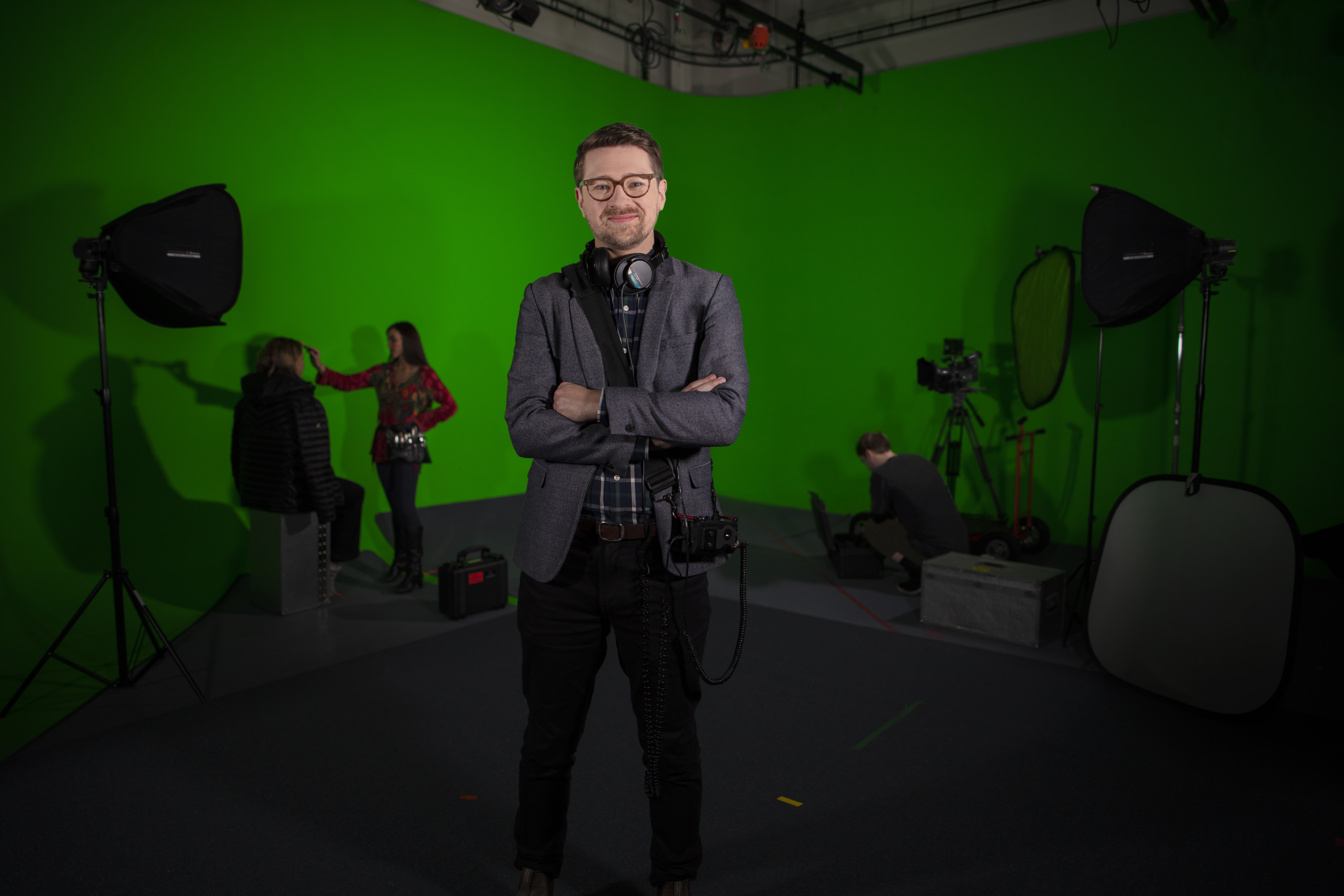 Associate Professor Dan Golding standing in front a green screen in a film studio