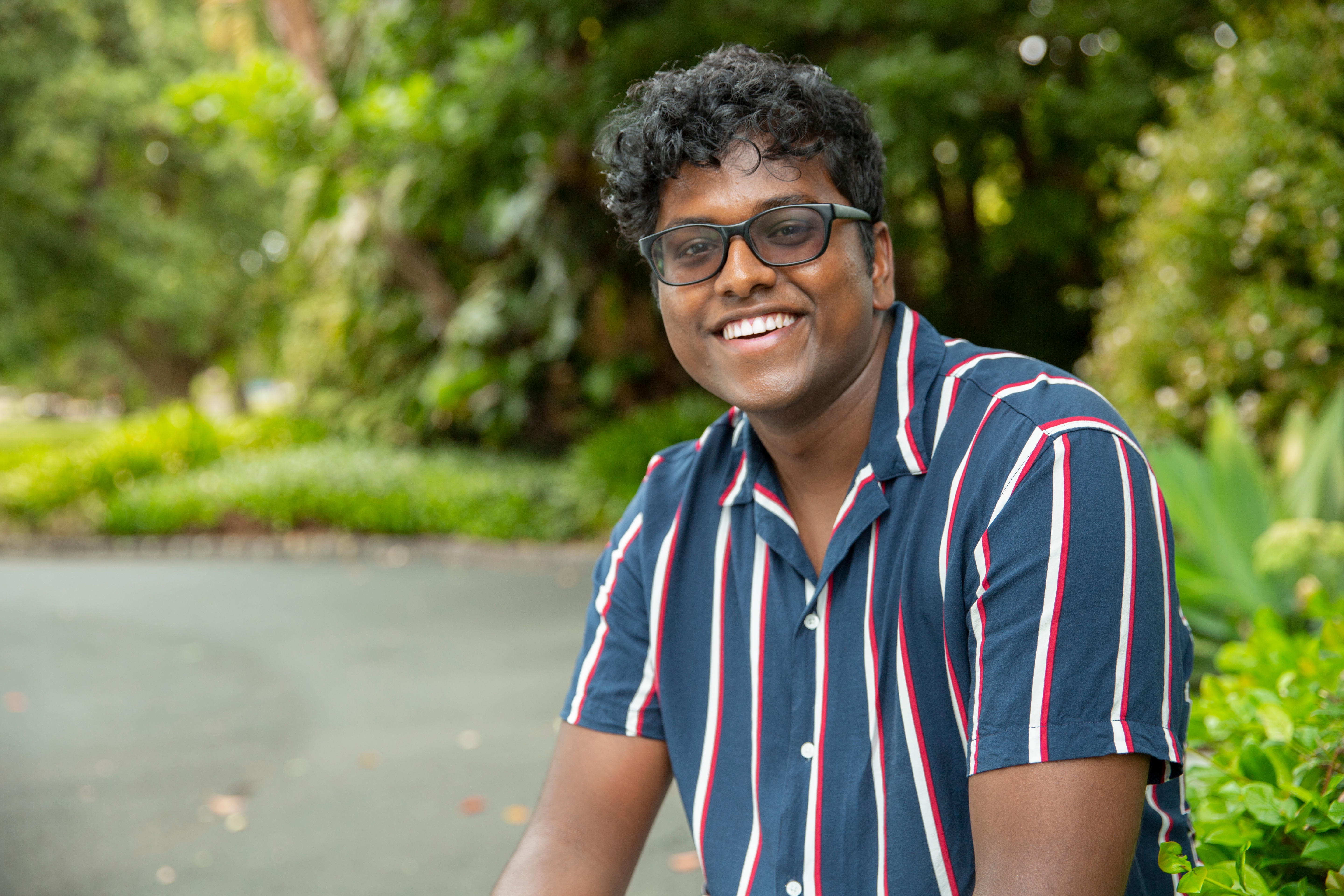 Swinburne student Minura sits in the green surrounds of Hawthorn’s Central Gardens 