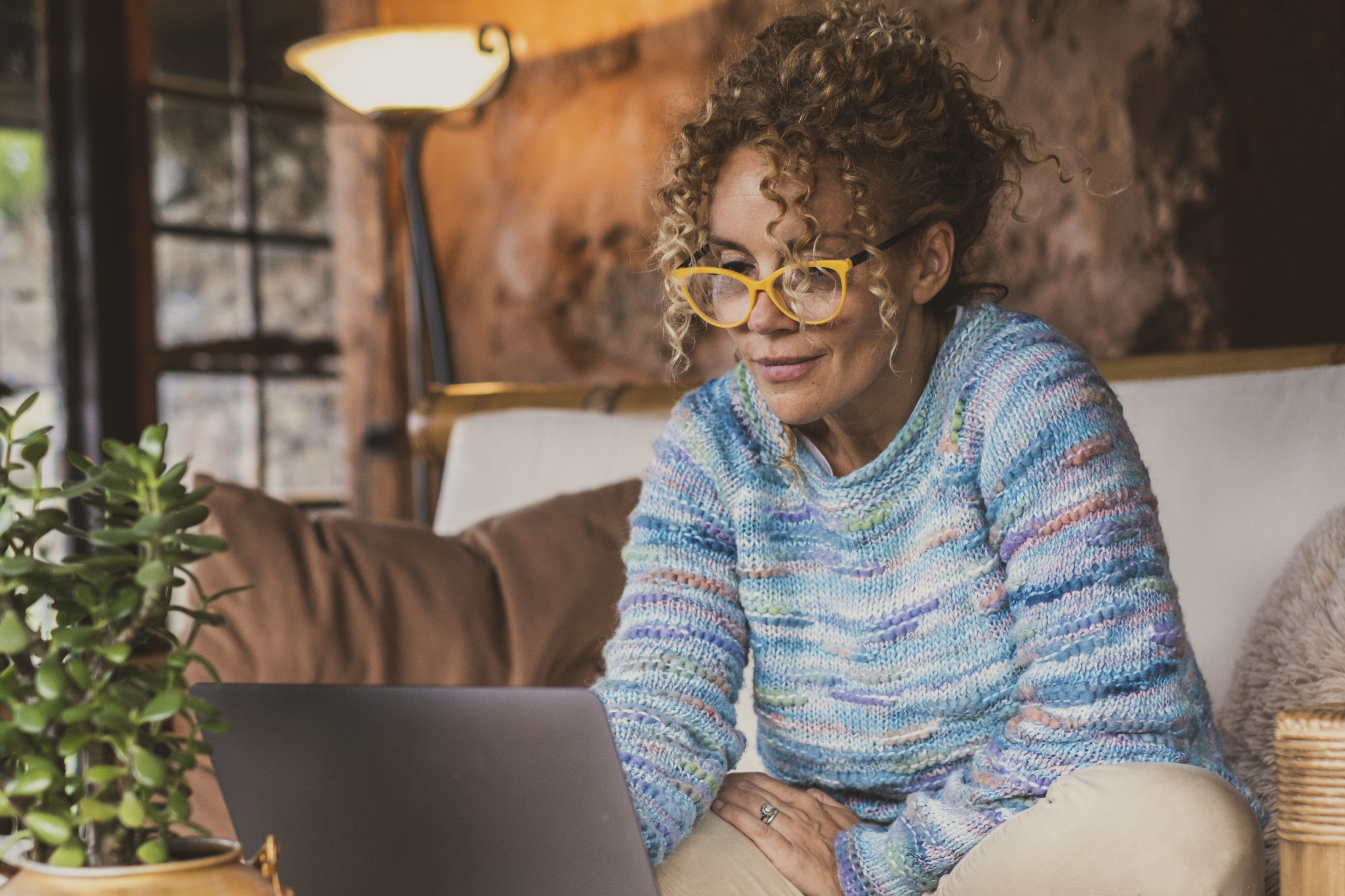 Smiling Woman Using Laptop At Home.