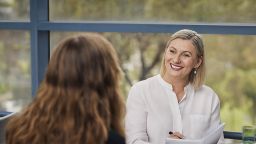 Diploma of Community Services student Dorota smiling and having a friendly conversation with a client during a counselling session.
