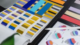 colour blending and matching from a book and tablet with blues and yellows for comm design