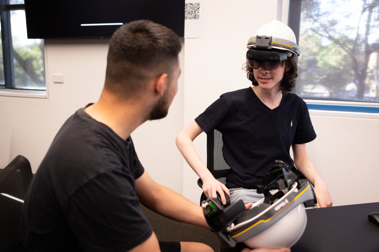 Students using the Trimble XR10 mixed reality headset for construction planning and progress monitoring.