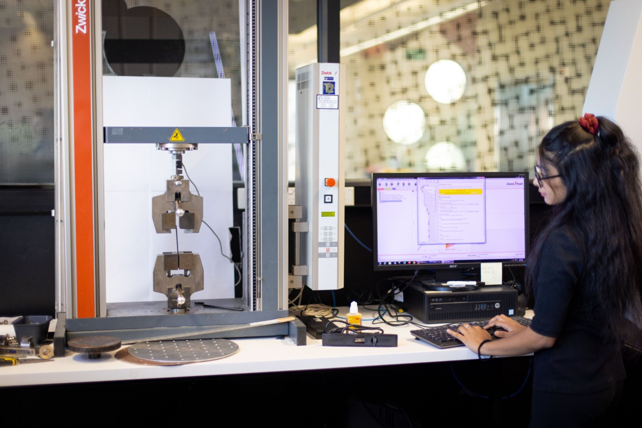 A student using the Zwich Z010 Universal Testing Machine to evaluate a material’s mechanical properties in the Polymer Processing and Testing Lab.