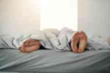 Couple's feet at the end of a bed