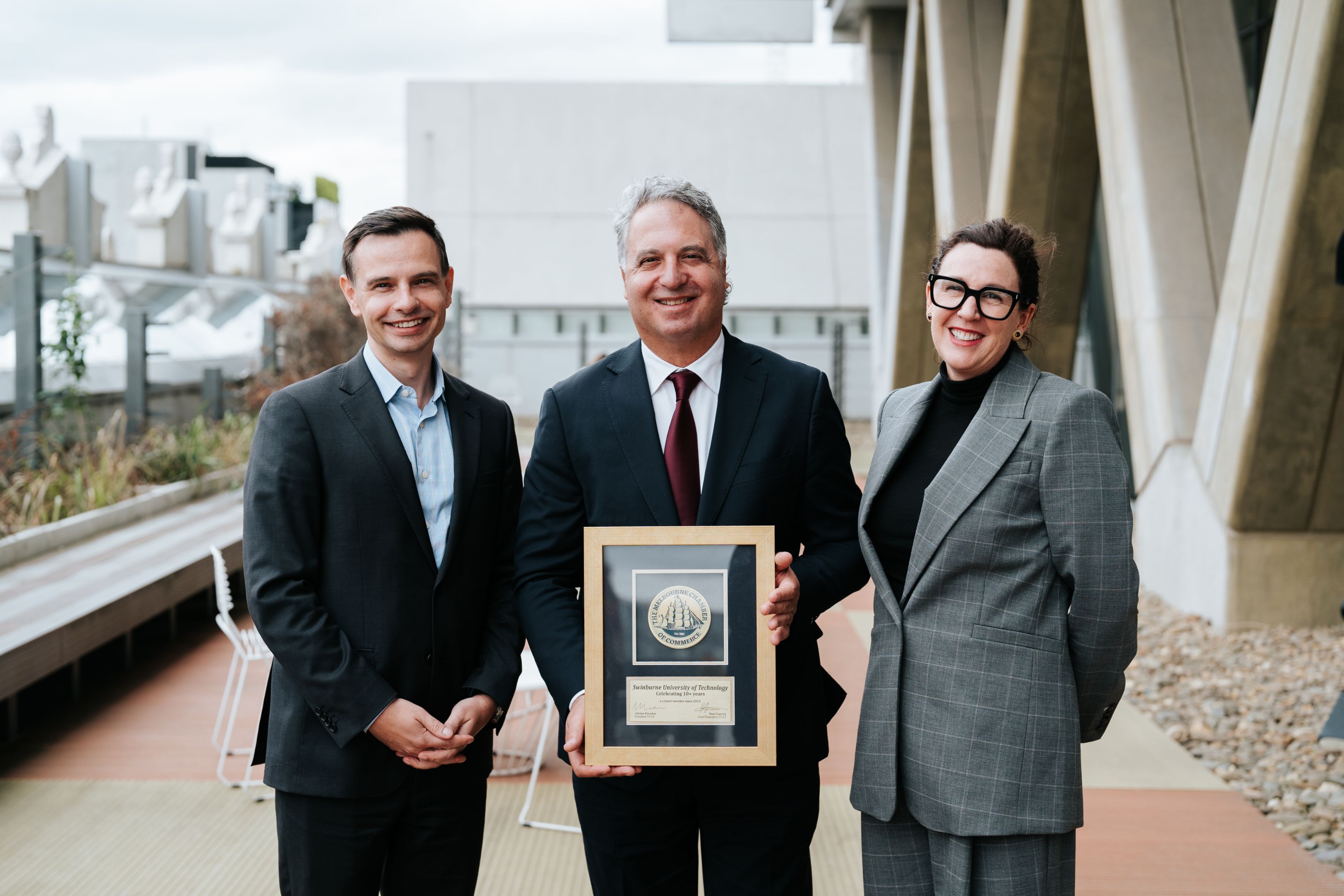 Smiling Swinburne industry professionals posing for photo