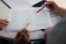 Two people looking over building plans.