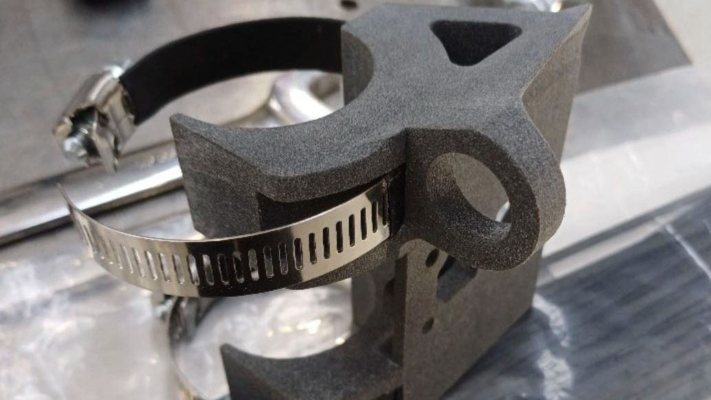 Tom and a teammate attaching a steering wheel to Team Swinburne’s race car. 