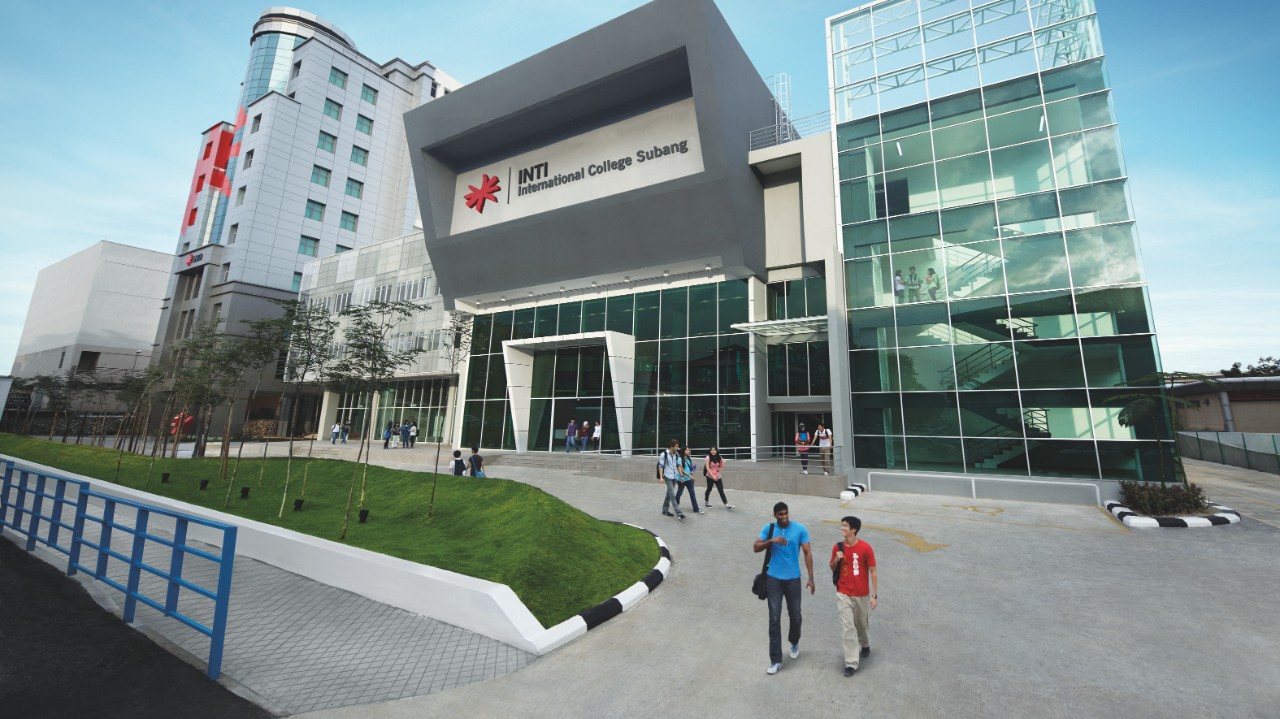 External view of a modern university campus building with students outside.