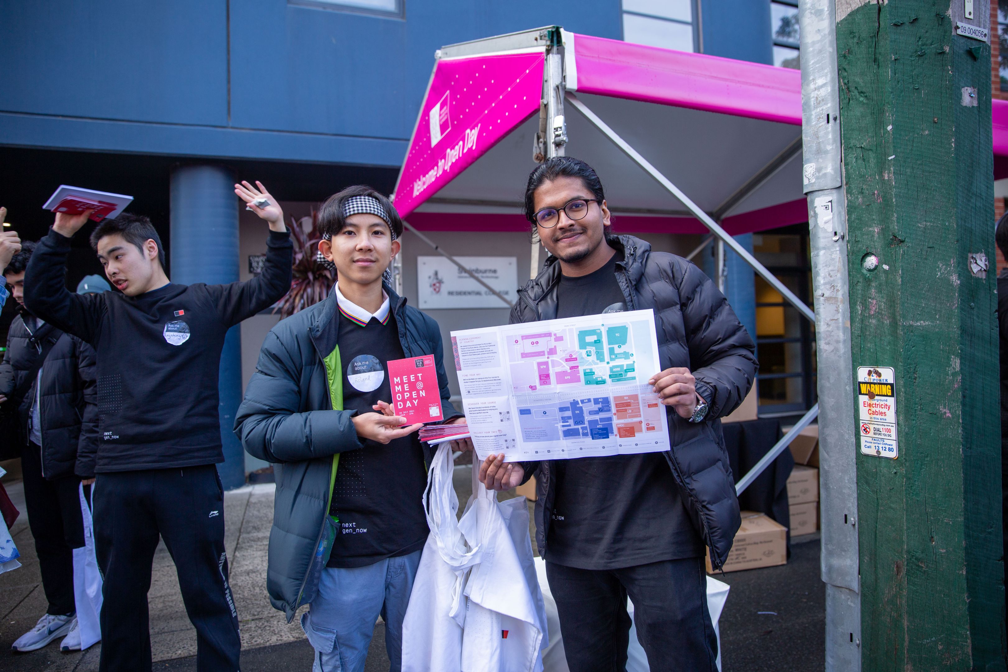 Two Open Day volunteers hold a colour-coded map of Swinburne’s Hawthorn campus 