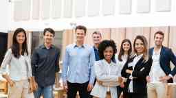 Young corporate professionals gathered together at a conference.