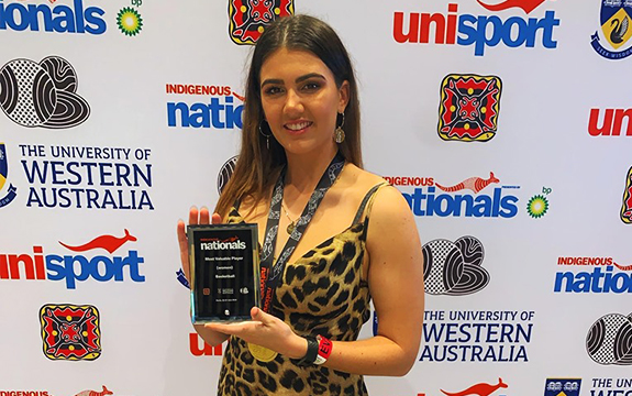 katie Bugden holding most valuable player trophy