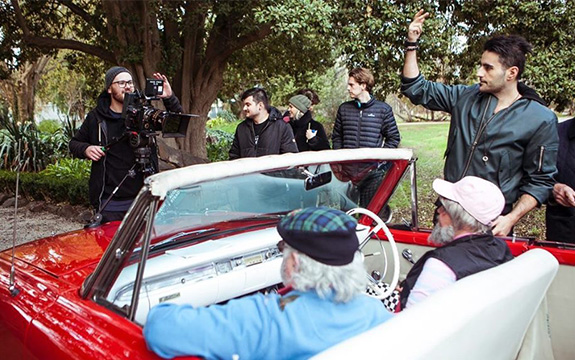 Swinburne alumnus and filmmaker, Nick Kozakis (right) on set of the ‘Dance Monkey’ music video. 