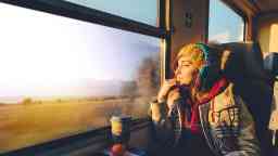 Thoughtful woman in the train looking through the window