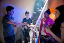 Young man in a peer pressure encounter gets offered cannabis joint at a house party..