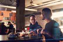Young people in a club having drink and snack
