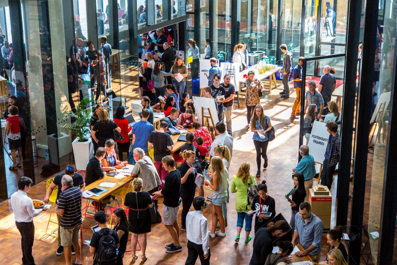 A large gathering of students attend an event it the ATC building