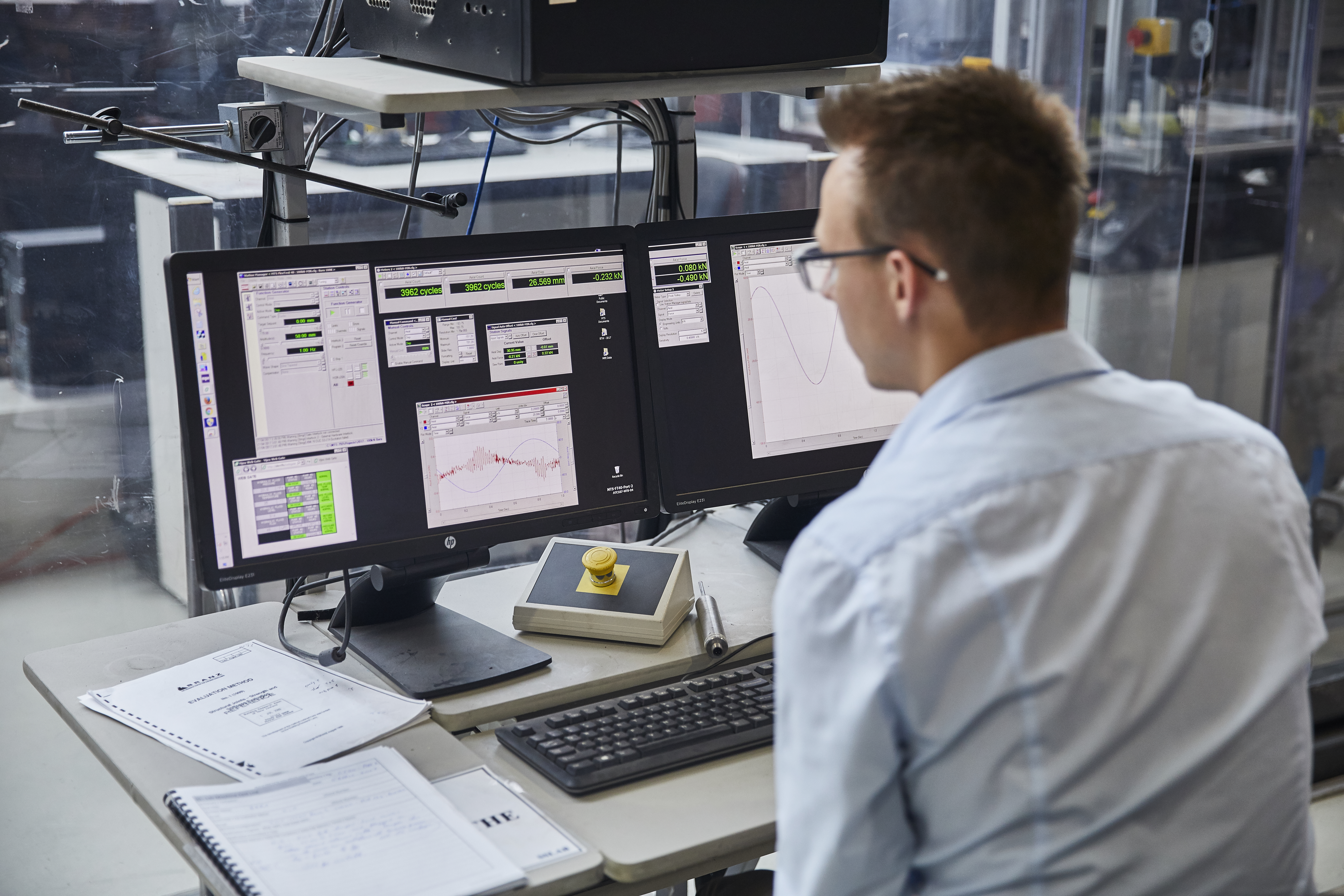 An engineering student sits at a computer and runs various automation programs