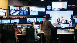 A group of people working in a TV studio environment using high-tech filming equipment.