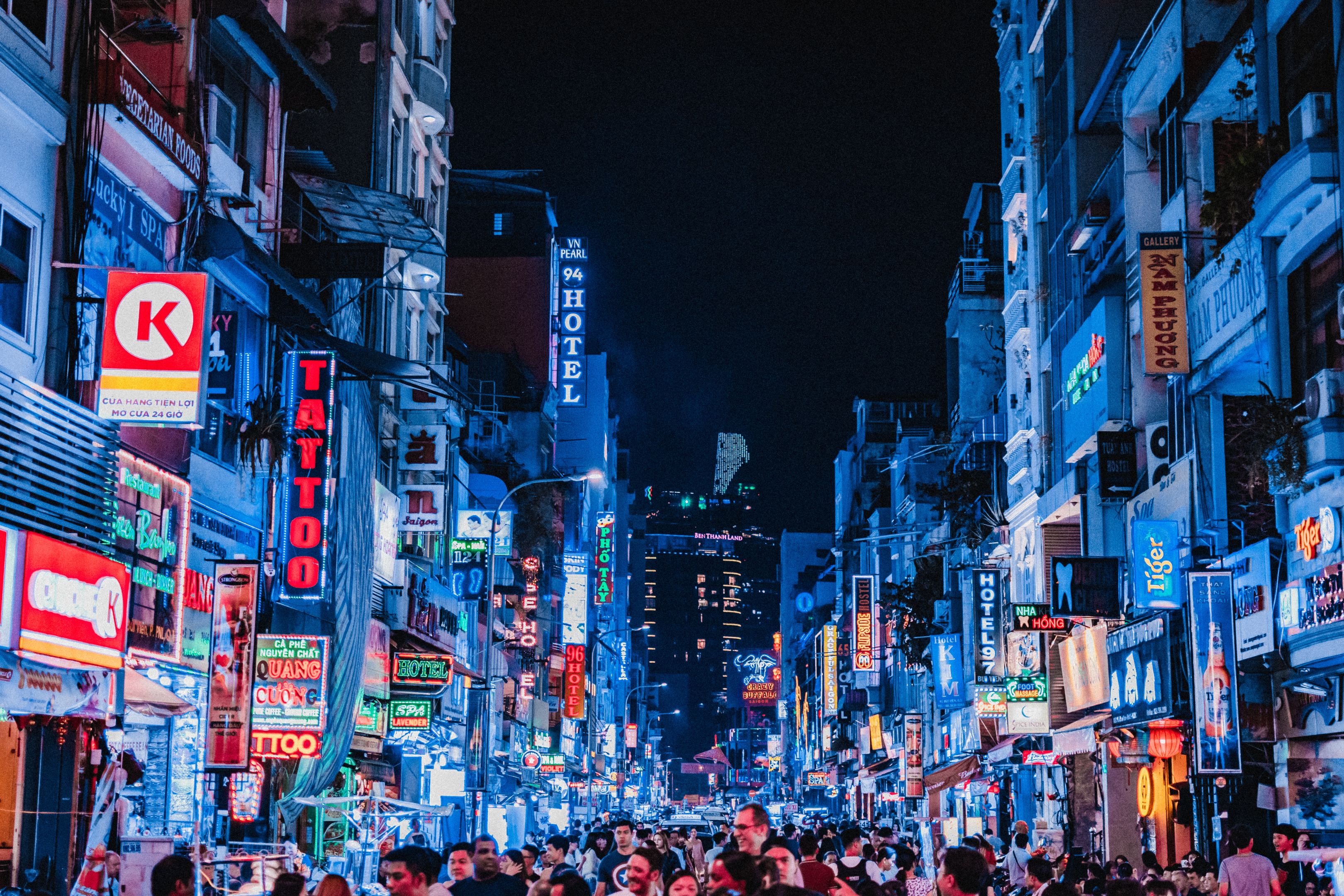 Image of street and building in Ho Chi Minh City at night.