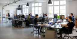 Busy modern open plan office with staff