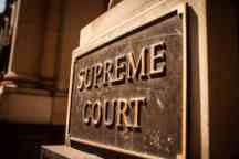 Close up of the Supreme Court plaque on the building