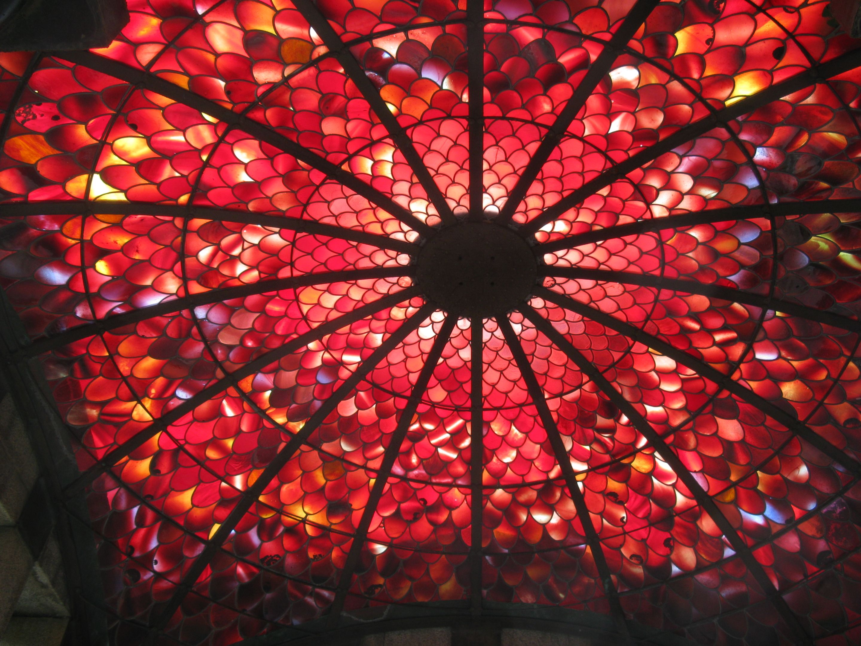Red and yellow fish-scale shaped stained glass tiles on the ceiling of the Springthorpe Memorial.