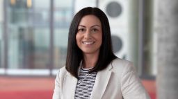 Lady with straight black hair in white jacket in AMDC Building