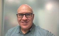 Professor Brenton Hall headshot smiling inside