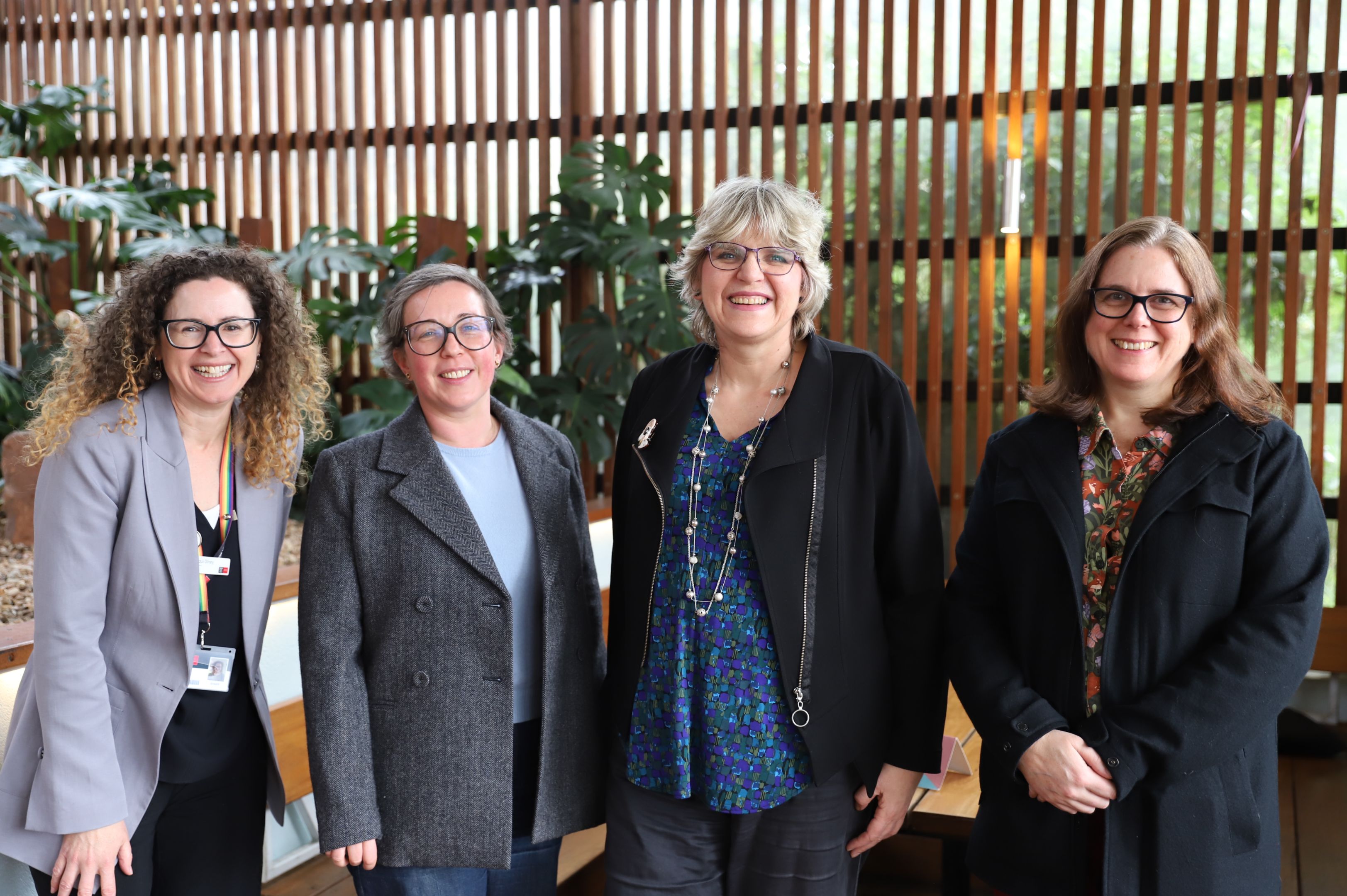 Professionals, academics and researchers standing at restaurant
