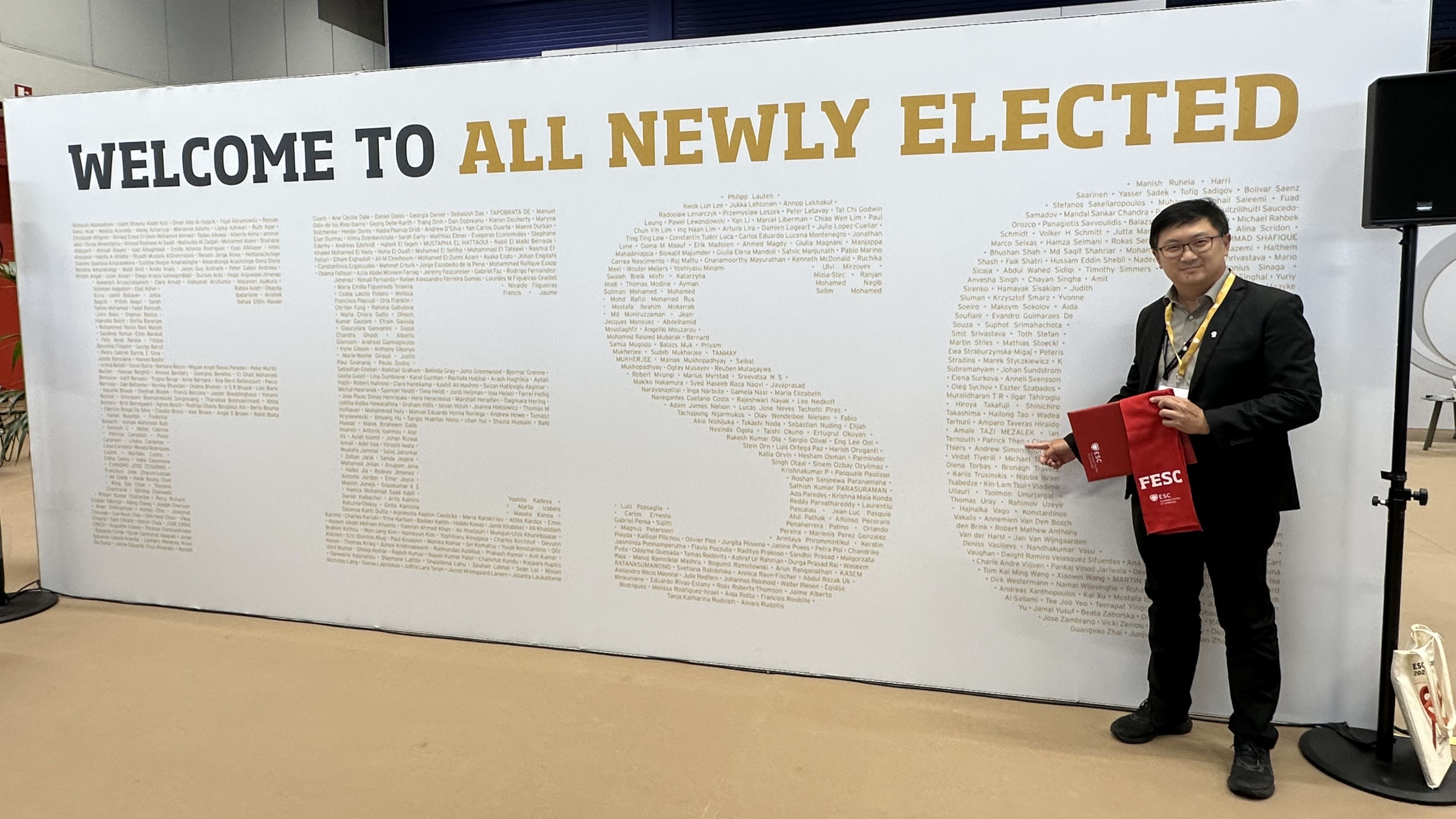 Man standing in front of text board.