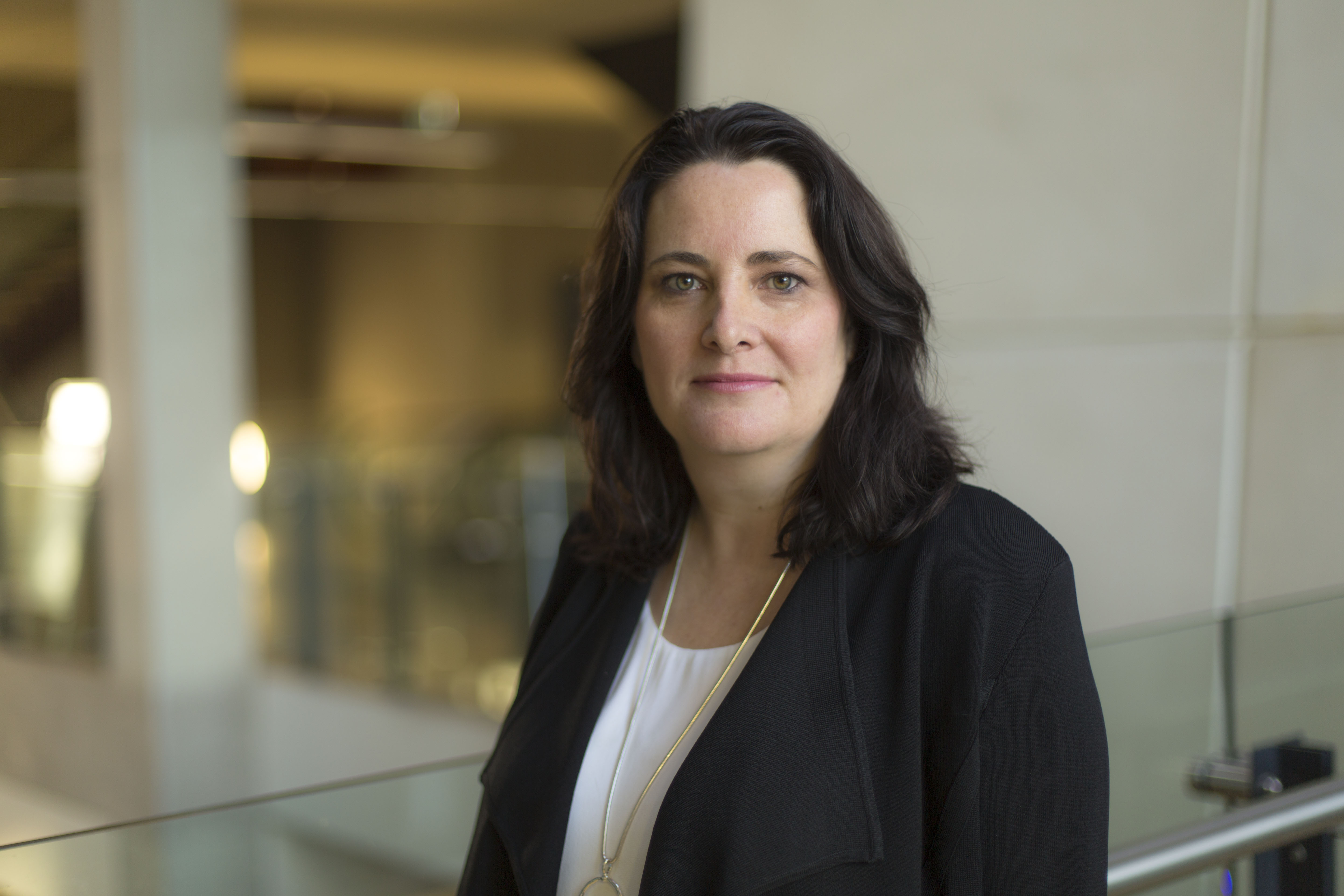 Woman professionally dressed standing inside a building