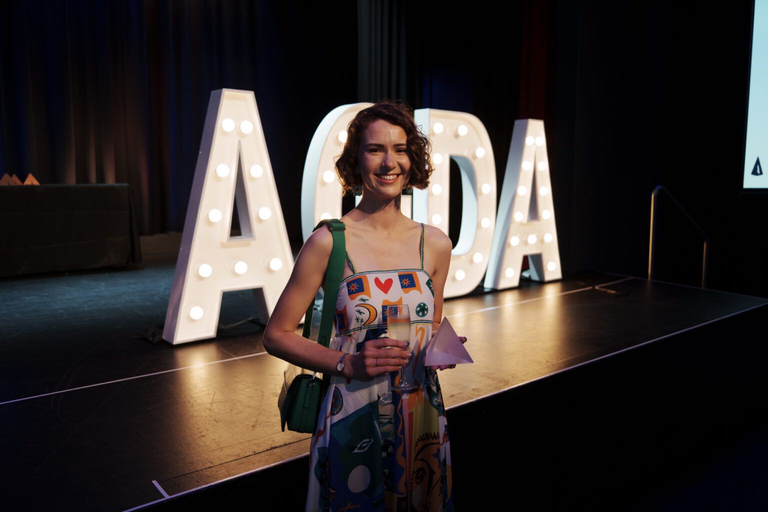 Alum Maddy Merzvinskis holding the Emerging Designer Award given by the Austrailan Graphic Design Association