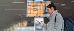 Young brunette girl at airport on her phone