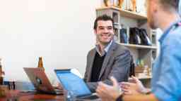 Male student working at a job after graduation