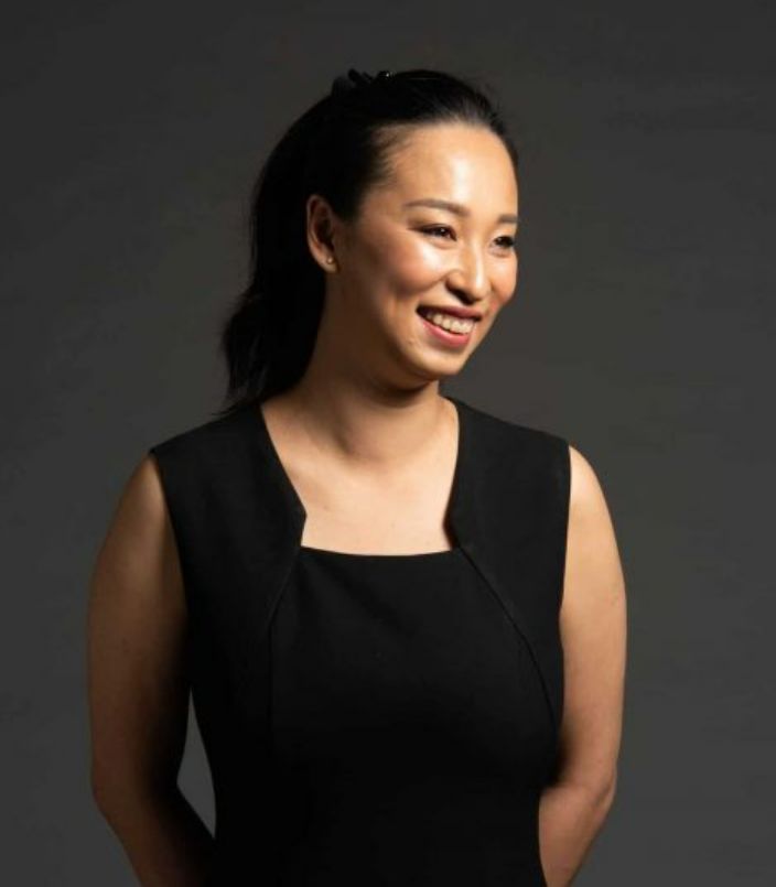 Swinburne alum Cassandra Chiu standing with her hands behind her back