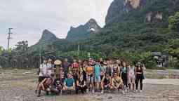 Group of students smiling at the camera with the mountains in the background