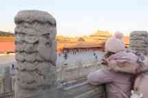 Female in pink looking towards a temple in Beijing China