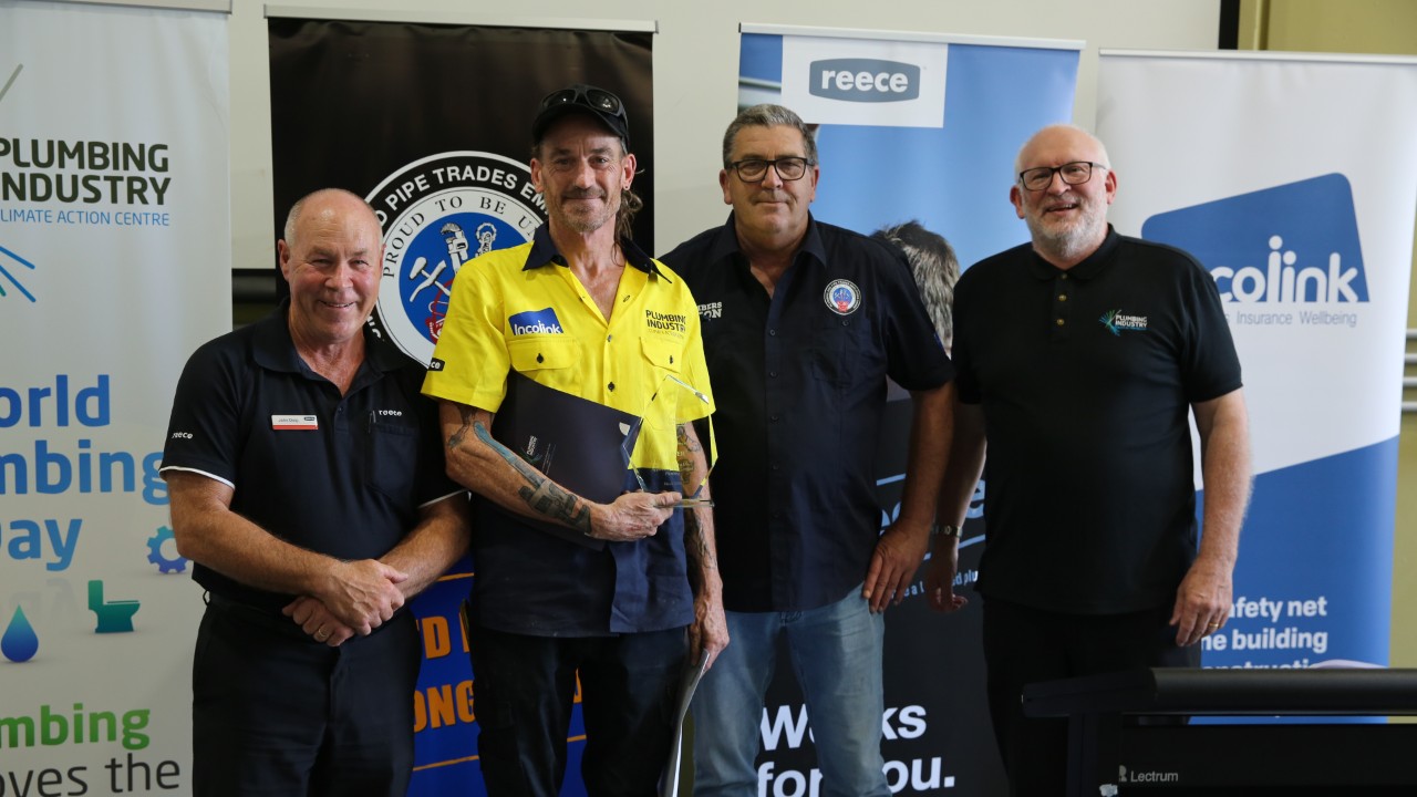 Swinburne student & 1st prize winner Matt Steward stands with the group. He is holding a certificate and a glass trophy
