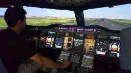 Man in a cockpit of an airplane looking out the front window