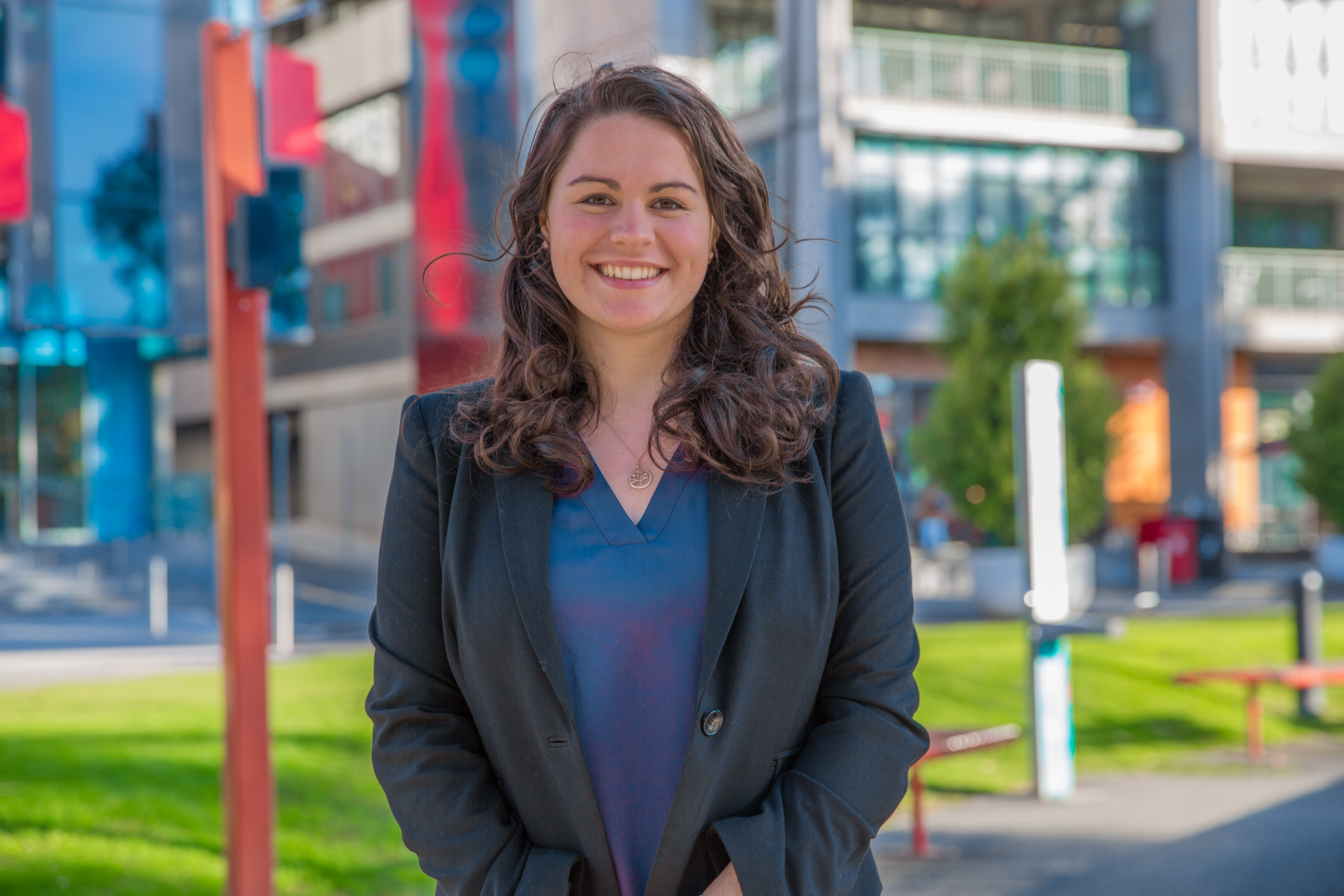 female student smiling in front of GS building