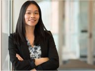 Professional looking woman facing camera smiling with arms crossed