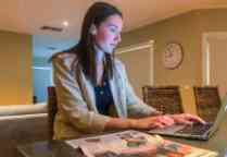 A student using a computer at home 