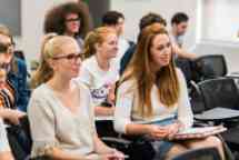 Students sitting and listening in class to their tutor