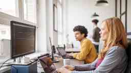 Female software programmer working with computers