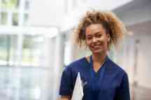 Portrait   Female Nurse  Scrubs  Hospital Work  Smiling  Happy  Clipboard 