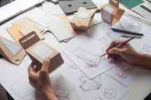 Designer sketching drawing design Brown craft cardboard paper product eco packaging mockup box development template package branding Label . designer studio concept .