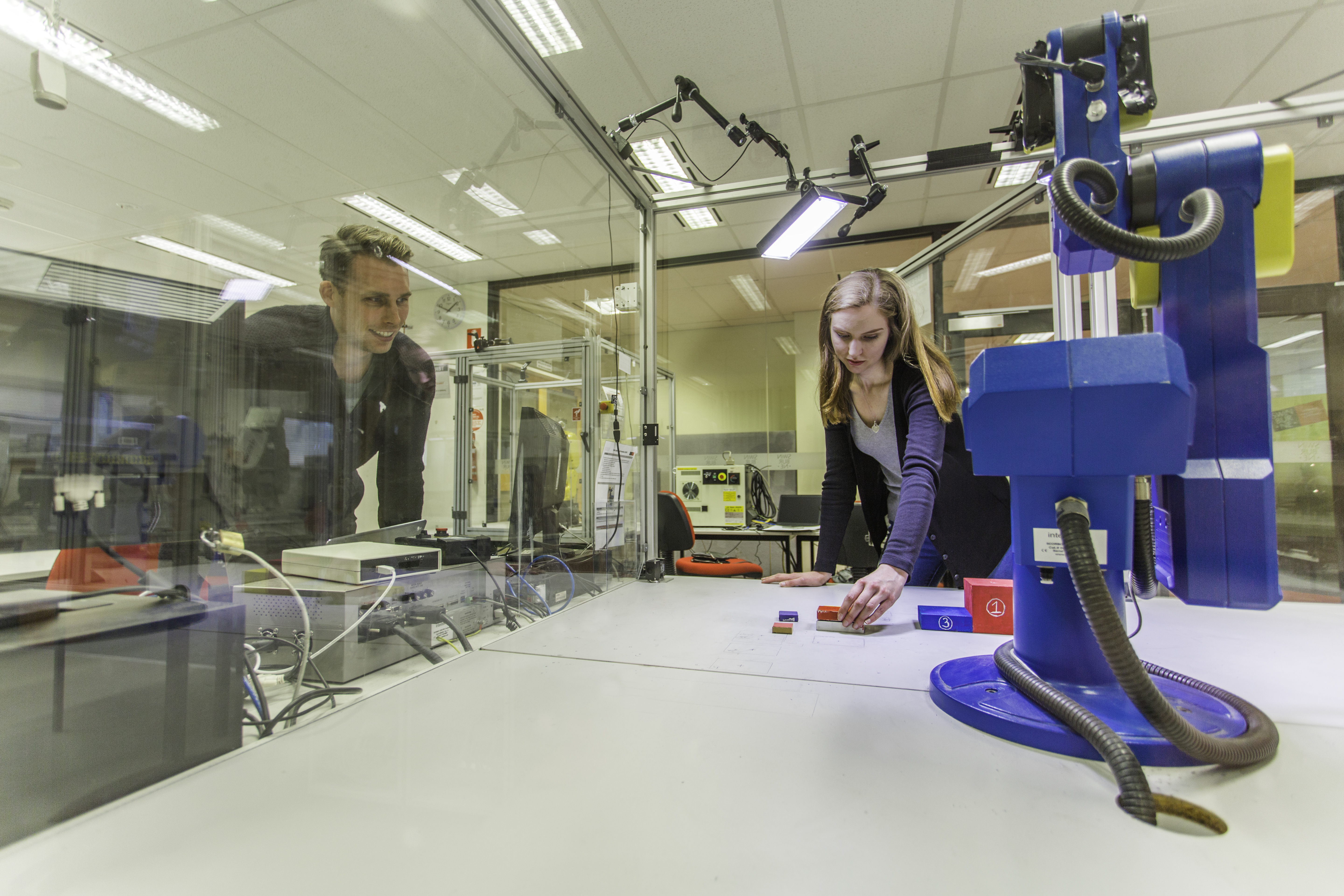 Robotics and mechatronics course students program a robotic arm