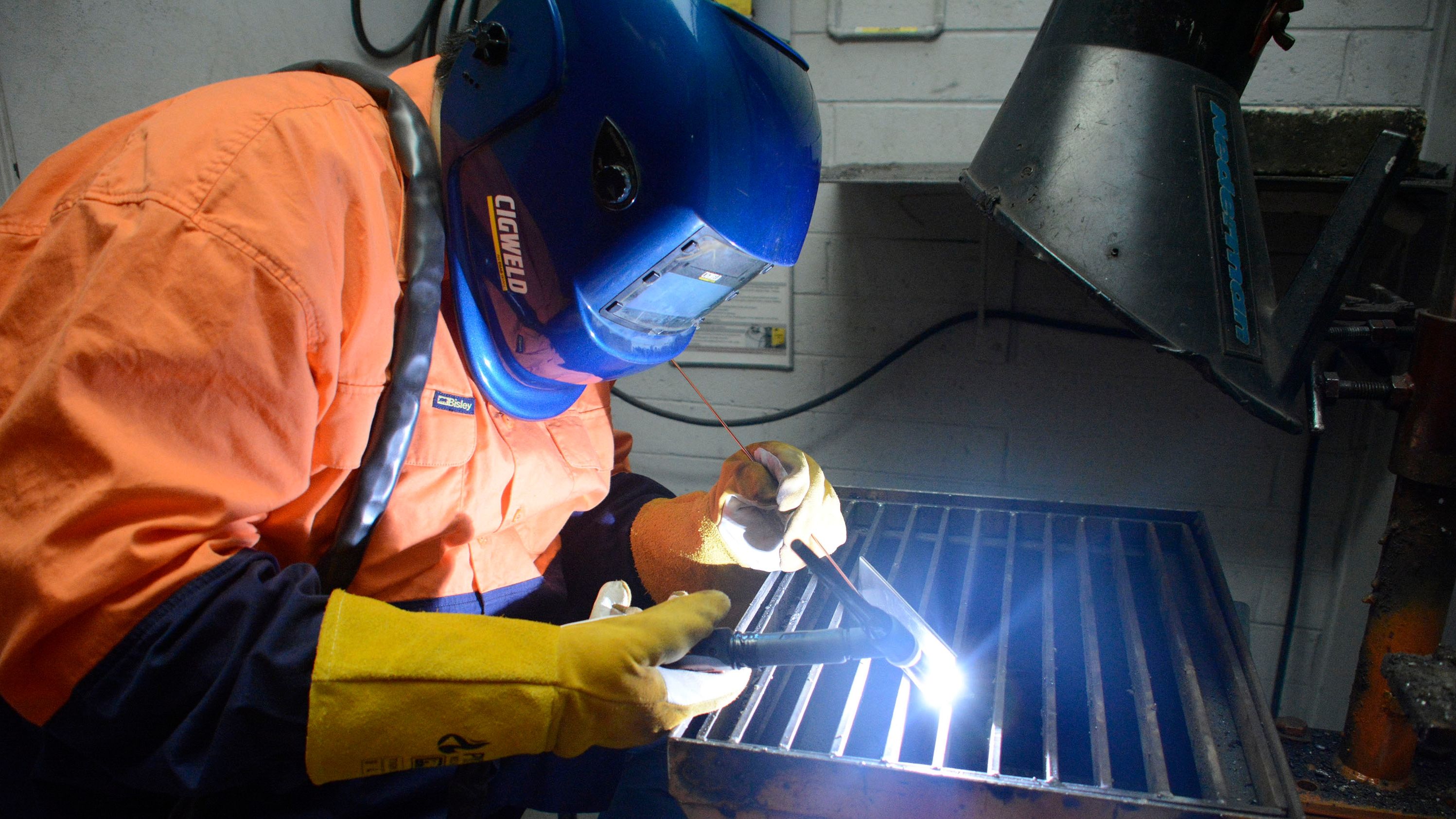 Swinburne student operating welding soldering equipment whilst wearing protective gloves and gear. Swinburne students operating welding soldering equipment whilst wearing protective gloves and head gear.. 
